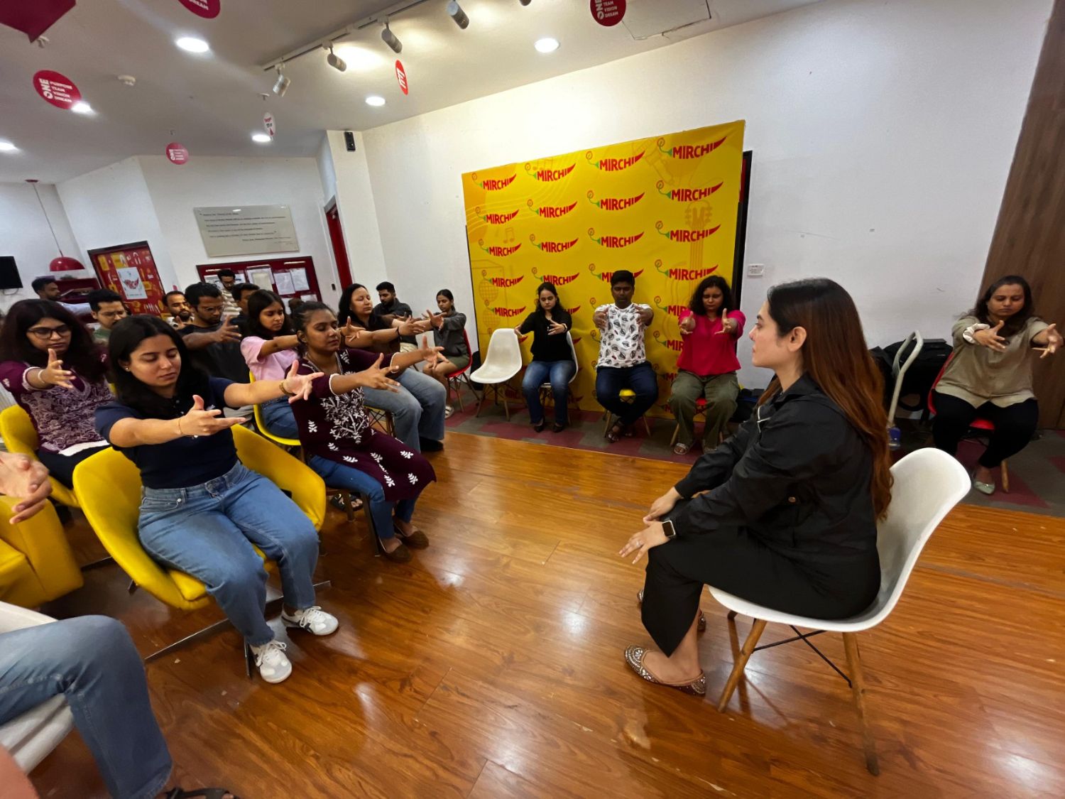 Vibha Jain leading a group relaxation and awareness session with participants seated in a circle in Mumbai